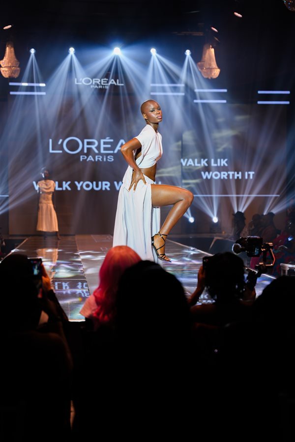 Runway model beneath L’Oréal Paris stage lighting